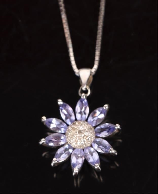 DIAMOND & TANZANITE 14KT GOLD FLOWER NECKLACE: Diamond & Tanzanite 14 karat White Gold Flower design Necklace. To feature:Cluster of round cut diamonds portraying the seeds of a flower, and marquise cut Tanzanite to portray the petals.Stone Type: 