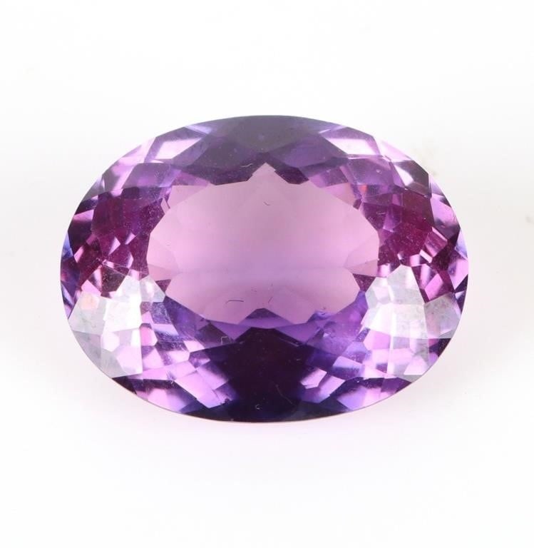19.80 CARAT OVAL CUT BICOLOR PURPLE/PINK SAPPHIRE: 19.80 carat oval cut bicolor purple/pink sapphire measuring 22.5 mm X 13.0 mm. Stone Type: Sapphire Weight: 3.96 Grams Size: 22.5 mm X 13.0 mm Condition: Very fine.
