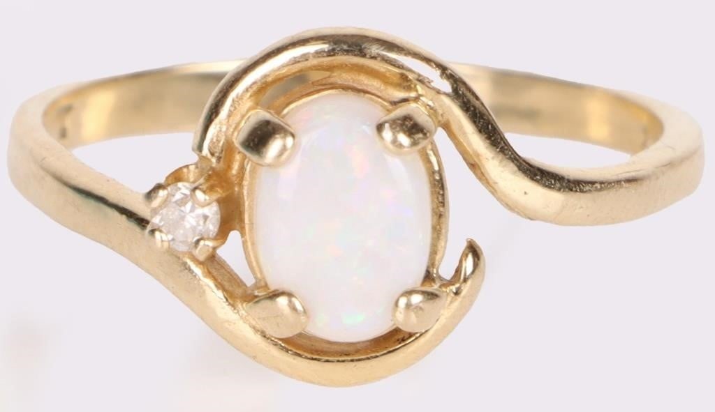 14K YELLOW GOLD DIAMOND OPAL LADIES RING: 14k yellow gold diamond opal ladies ring with one 0.01ct round diamond. Stone Type: Assorted Weight: 2.3 Grams Size: US 7.25 Condition: Very fine.