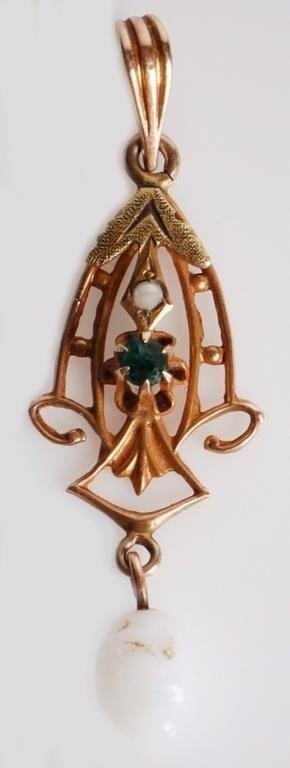 10 KT. VINTAGE ORNATE FLOWER SHAPED PENDANT: 10 karat yellow Gold vintage Ornate Pendant featuring a green glass stone surrounded by a flower shaped setting. Includes a drop element opaque white stone. Condition: Fine. See images.