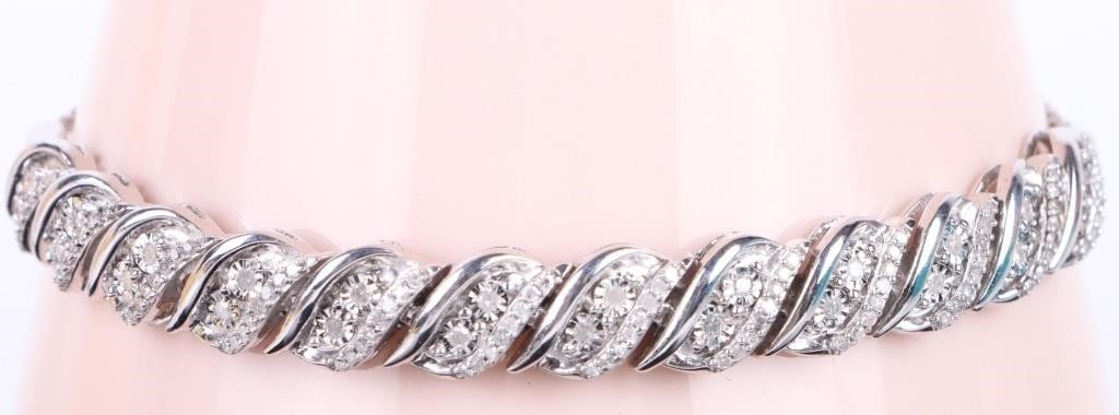 STERLING SILVER 'S' LINK DIAMOND TENNIS BRACELET: Sterling silver "S" link diamond tennis bracelet. Stone Type: Diamond Weight: 9.51 Grams Size: 8" Condition: Very Fine