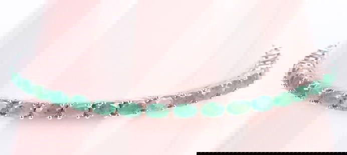 7.40CTW GREEN EMERALD STERLING SILVER BRACELET: 7.40CTW green emerald sterling silver ladies bracelet with thirty-seven 0.20ct oval emeralds.Stone Type: EmeraldWeight: 9.21 GramsSize: 8.5" LengthCondition: Very fine.