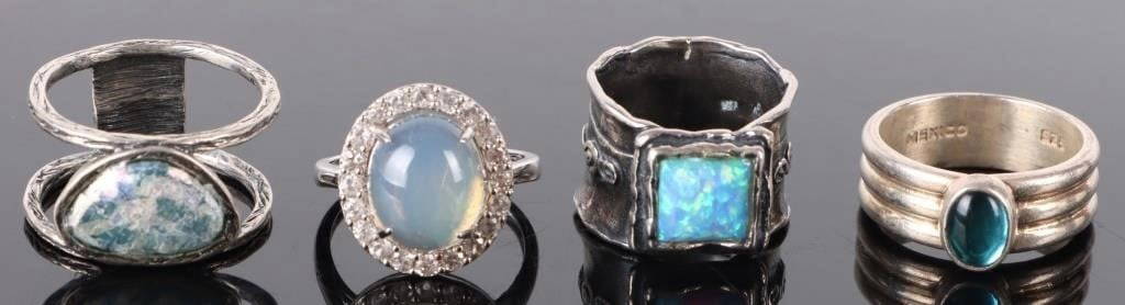 OPAL & MOONSTONE STERLING SILVER LADIES RINGS: Opal and moonstone sterling silver ladies rings with two blue opal ladies rings and two moonstone rings.Stone Type: AssortedWeight: 23.08 gramsSize: Varies.Condition: Very fine.