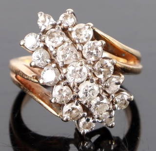 10K YELLOW GOLD DIAMOND LONG CLUSTER LADIES RING: 10K yellow gold diamond elongated cluster ladies ring. Gemstones to include thirteen 0.05ct round cut diamonds, and six 0.03ct round cut diamonds.Stone Type: DiamondWeight: 4.69 GramsSize: 3.75