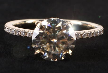 10K YELLOW GOLD MOISSANITE LADIES RING: 10K yellow gold moissanite ladies ring. Gemstones to include one 2.00ct round cut moissanite, twenty-eight 0.01ct round cut diamonds, and twenty 0.005ct round cut diamonds.Stone Type: DiamondWeight: