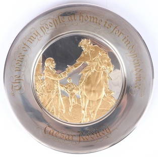 THE FRANKLIN MINT 1975 FINE SILVER 24K GOLD PLATE: The Franklin Mint 1975 fine silver and 24k gold plate. The plate is the 1975 Bicentennial Commemorative plate. Comes with original box. Caesar Rooney.Weight: 240 gramsSize: 8.0" LengthCondition: Very