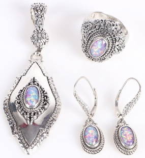 DESIGNER SARDA STERLING SILVER FAUX OPAL JEWELRY: Designer Sarda sterling silver faux purple opal ladies jewelry to include one ring, one pendant, and one pair of earrings.Stone Type: OpalWeight: 34.84 GramsSize: 3.0" lengthCondition: Very fine.
