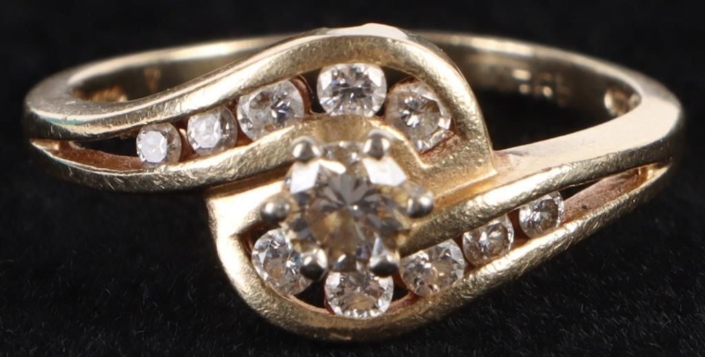 14K YELLOW GOLD DIAMOND LADIES RING: 14k yellow gold diamond ladies ring with one 0.25ct round diamonds and ten 0.03-0.02ct round diamonds. Stone Type: Diamond Weight: 3.18 Grams Size: US 6.25 Condition: Very fine.