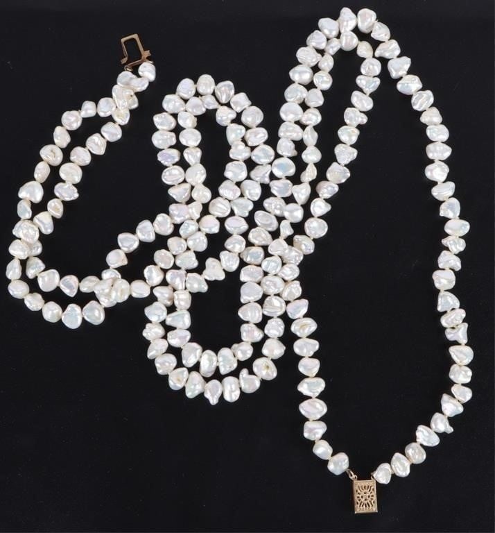 14K YELLOW GOLD CLASPED BAROQUE PEARL NECKLACE: 14k yellow gold-clasped baroque white pearl ladies two-strand necklace. Stone Type: Pearl Weight: 56.68 Grams Size: 26" length Condition: Very fine.