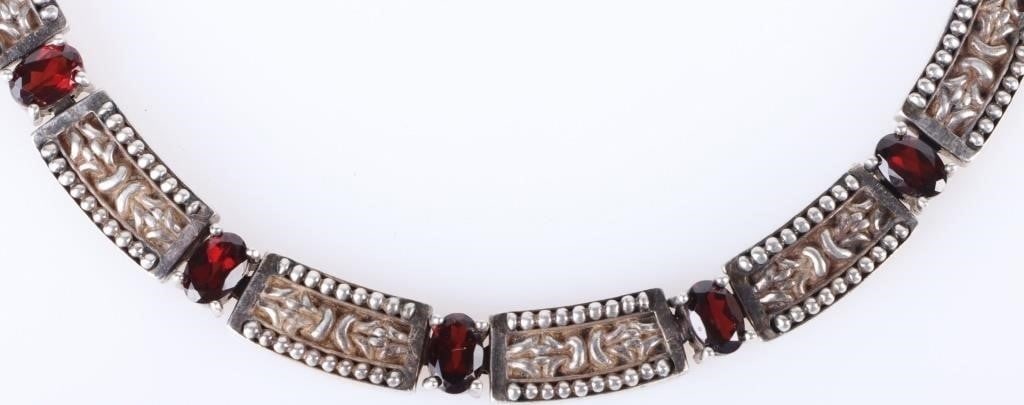 STERLING SILVER GARNET LADIES NECKLACE - 11.5CTW: Sterling silver garnet ladies necklace with twenty-three 0.50ct oval garnets. 11.50CTW. Stone Type: Garnet Weight: 73.61 Grams Size: 17.5" Length Condition: Very fine.