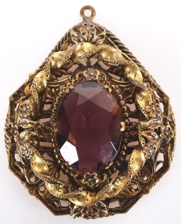 VICTORIAN ANTIQUE INTRICATE PENDANT: Antique intricate brass pendant features a large stone centerpiece surrounded by detailed exterior.Condition: Very fine. See images.