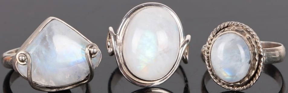 SOUTHWEST-STYLE MOONSTONE STERLING SILVER RINGS: Southwest-style moonstone sterling silver ladies rings. There are 3 rings included in this lot. The triangle shaped ring is a size 7, the small oval is also a size 7 and the larger oval with the loops