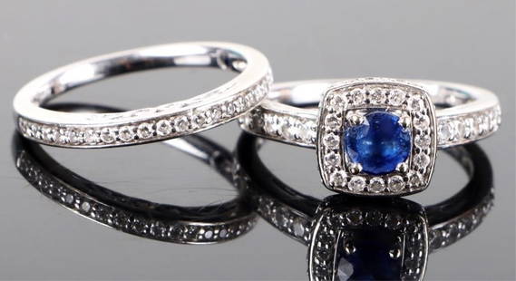 14K DIAMOND & SAPPHIRE ENGAGEMENT RING SET: 14K white gold diamond & sapphire engagement ring set. One is a .33CT diamond-cut sapphire surrounded by many more smaller sapphires along with ten .015CT diamonds on the ring's face. The other has ni