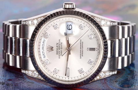 ROLEX DAY-DATE 36 18K WHITE GOLD LADIES WATCH: Rolex day-date 36 solid 18K white gold & diamonds ladies watch. Silver dial set with diamonds.10 diamonds set on dial. 32 diamonds set on case. Solid 18K white gold fluted bezel. Day and date features