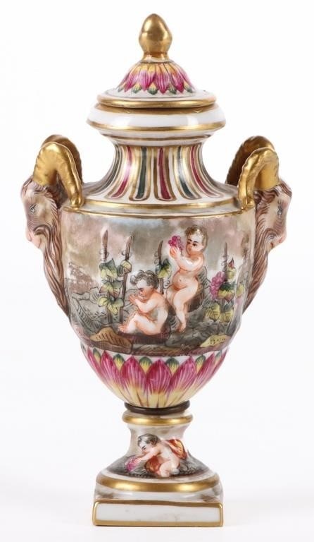CAPODIMONTE 1800'S FRENCH 6' PORCELAIN URN: Capodimonte 1800'S French 6" porcelain urn to depict two babies amidst a vineyard with two goat heads as the handles.Size: 3.25" X 6.00"Condition: Very fine.