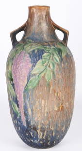 1933 ROSEVILLE POTTERY WISTERIA VASE 641-15': Antique 1933 Roseville Pottery Wisteria Vase 641-15" with the original emblem on the base. Mild craquelure present along the surface of the vase.Size: 7.00" X 15.25"Condition: Mild craquelure present