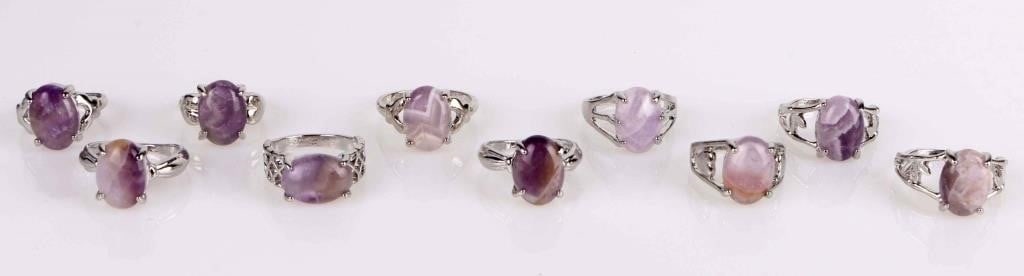 PURPLE NATURAL AMETHYST LADIES SILVER-TONE RINGS: Purple natural amethyst ladies silver-tone rings - lot of 10. Stone Type: Amethyst Weight: 37.26 Grams Size: Varied Condition: Very fine.