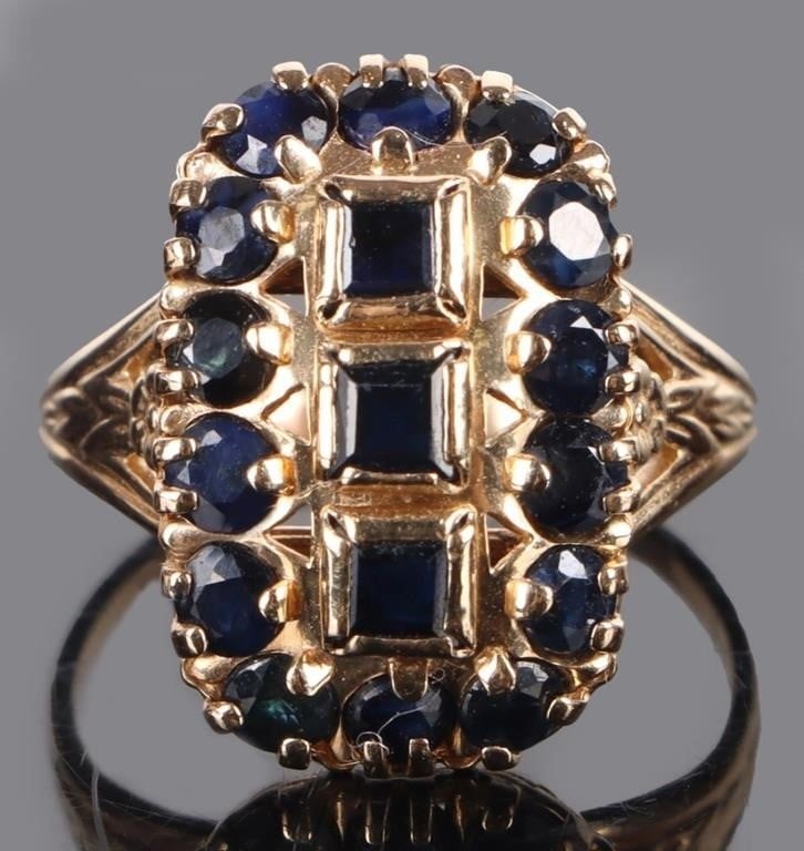 BLUE SAPPHIRE 10K YELLOW GOLD LADIES RING: Blue sapphire 10k yellow gold ladies ring with three 0.10ct princess-cut sapphires and fourteen 0.06ct round sapphires.Stone Type: SapphireWeight: 3.0 GramsSize: US 6Condition: Very fine.