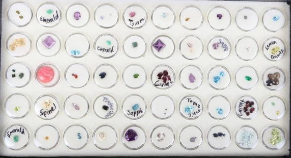 ~300CTW ASSORTED SEMI-PRECIOUS GEMSTONE LOT: ~300ctw assorted semi-precious gemstone lot to include sapphire, emerald, amethyst, garnet, peridot, tourmaline, quartz and more. Item contains 50 capsules of various different gemstones.Stone Type: A