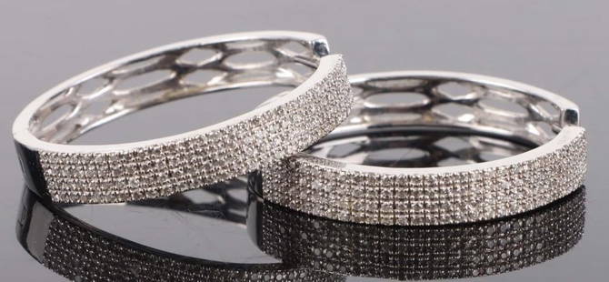 14K WHITE GOLD DIAMOND LADIES HOOP EARRINGS: 14K white gold diamond ladies hoop earrings. Gemstones to include one-hundred-twenty 0.01ct round cut diamonds per each earring.Stone Type: DiamondWeight: 10.06 GramsSize: 1.25"Condition: Very fine.