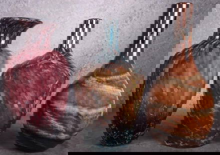 MURANO & ART GLASS COLLECTIBLE LARGE VASES: Murano and art glass collectible large vases to include one purple-red Murano vase, one muted rainbow swirl art glass vase, and one amber and brown swirled art glass vase.Size: 16" LengthCondition: Ve