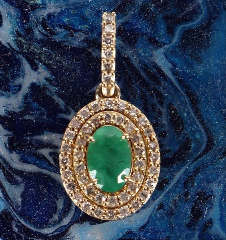 10K YELLOW GOLD LADIES PENDANT W/ EMERALD & 52 DIA: 10k yellow gold ladies pendant with one .2k emerald surrounded by 52 melee diamonds.Stone Type: DiamondWeight: 1.13 gramsSize: 7/8"Condition: Very fine.