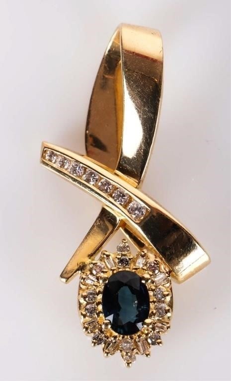 14K YELLOW GOLD SAPPHIRE DIAMOND RIBBON PENDANT: 14K yellow gold sapphire diamond ribbon ladies pendant. Gemstones to include one 0.50ct oval cut sapphire, seven 0.03-0.04ct round cut diamonds, and twenty 0.01ct round and baguette cut diamonds Stone