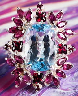 ORNATE TOPAZ & DIAMOND STERLING SILVER LADIES RING: Sterling silver ornate topaz diamond garnet pink tourmaline ladies ring. Gemstones to include one 19.00 X 12.00 mm rectangular cushion cut blue topaz, four 0.33ct princess cut garnet, four 0.04ct