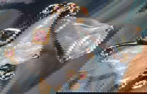 WHITE CARVED LABRADORITE STERLING SILVER RING: White carved floral and butterfly labradorite sterling silver gold-tone ladies ring with small peridot gemstones.Stone Type: AssortedWeight: 8.77 gramsSize: US 8Condition: New.