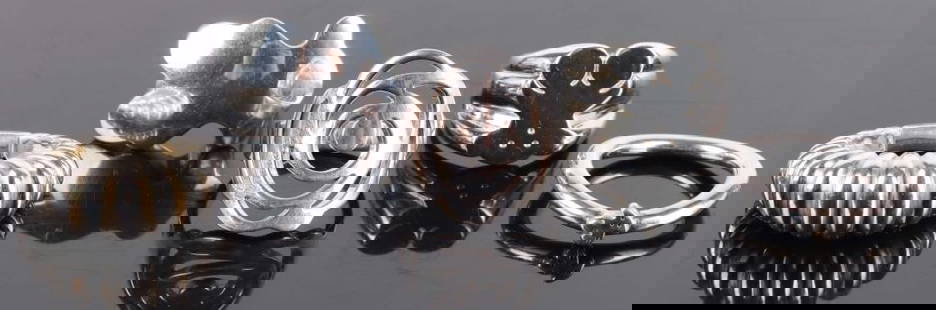 DESIGNER TOUS STERLING SILVER LADIES RINGS: Designer Tous sterling silver ladies rings. Rings include three teddy bear rings, one rose ring, and one rippled ring.Weight: 35.92 GramsSize: VariesCondition: Very fine.