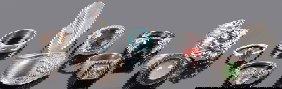 STERLING SILVER LADIES RINGS LOT OF TEN: Sterling silver ladies rings. This lot includes 10 different rings. One with a murky blue teardrop-shaped center stone, one with Mid Century Modern abstract designs, one in a rough twisted shape with