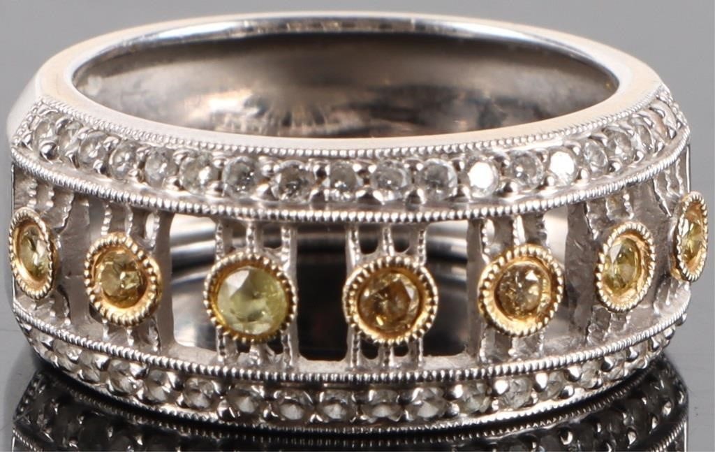 YELLOW CANARY DIAMOND 18K WHITE GOLD RING: Yellow canary diamond 18k white gold unisex ring with six 0.02ct round canary diamonds, one 0.02ct round spinel, and thirty eight 0.01ct round white diamonds.Stone Type: DiamondWeight: 6.10 GramsSize: