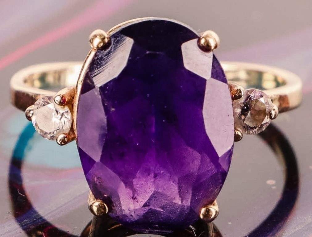 14K YELLOW GOLD PURPLE SPINEL CZ LADIES RING: 14K yellow gold purple spinel CZ ladies ring. Gemstones to include one 3.50CT oval cut purple spinel, and two 0.07CT round cut CZ.Stone Type: SpinelWeight: 3.37 GramsSize: 6.50 U.S.Condition: Gently u