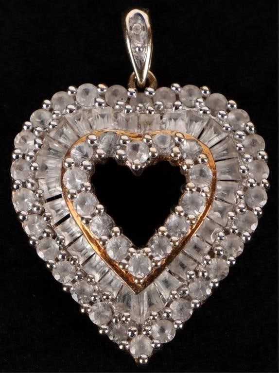 10K WHITE TOPAZ HEART PENDANT W/ ACCENT DIAMOND: 10K yellow gold white topaz heart pendant. The loop contains one melee diamond. The brand is The Highline JewelryStone Type: DiamondWeight: 4.22 GramsSize: 1.5" tallCondition: Very fine.
