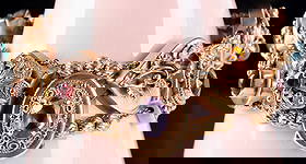 VINTAGE 14K YELLOW GOLD TRIPLE SLIDE BRACELET: Vintage 14k yellow gold triple slide bracelet with assorted gemstones to include jade, tiger's eye, amethyst, citrine, garnet, and coral. This bracelet has ten various-shaped charms.Stone Type: Assort