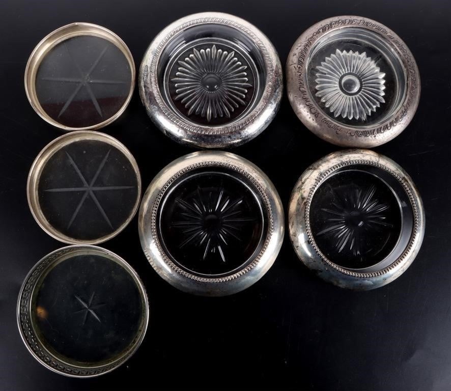 ASSORTED STERLING SILVER & GLASS COASTERS ( 6): Assorted sterling silver & etched glass coaster. This lot contains 6 different coasters. Some have a rounded rim and others have a thin rim.Weight: variesSize: 31/8Condition: Some surface wear. Please
