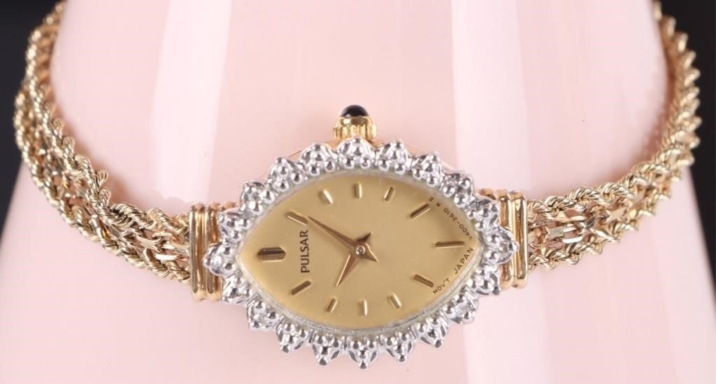 14K YELLOW GOLD PULSAR LADIES WRISTWATCH W/ SAPHRE: 14k yellow gold ladies Pulsar wrist watch with four small bright sapphires along the edge. The border around the watch face is white gold. Yellow Gold Pulsar Mens Weight: 10.64 grams Size: 21.3 X 16mm
