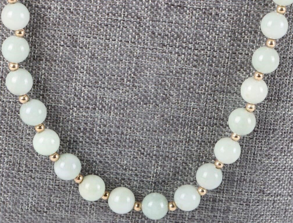 GREEN JADE 14K YELLOW GOLD BEADED NECKLACE: Light green jade 14k yellow gold beaded ladies necklace. Necklaces has 8.0-8.1mm jade beads.Stone Type: JadeWeight: 55.9 gramsSize: 26" lengthCondition: Some wear, see images for details.