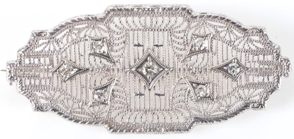 14K WHITE GOLD ART DECO FILIGREE SAPPHIRE PIN: 14k white gold art deco filigree sapphire ladies pin with six 0.03ct round white sapphire and one 0.04ct round white sapphire.Stone Type: SapphireWeight: 3.46 GramsSize: 1.5" lengthCondition: Barely u