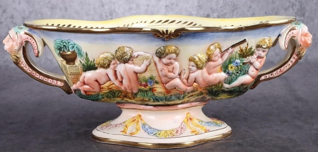 CAPODIMONTE LARGE CENTERPIECE BOWL ITALY: Capodimonte large centerpiece bowl from Italy adorned with cherubs. This bowl could possibly be a part of the Royal Collection. This bowl is beautifully done. The colors are very vibrant and show the