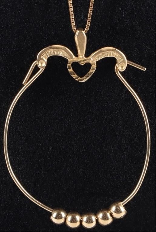 14K YELLOW GOLD LADIES NECKLACE W/ BEAD PENDANT: 14k yellow gold ladies necklace with a pendant that features a heart flanked by palm fronds and a hoop hanging beneath it with five gold spheres looped through it. Weight: 2.32 grams Size: 27.5" long 