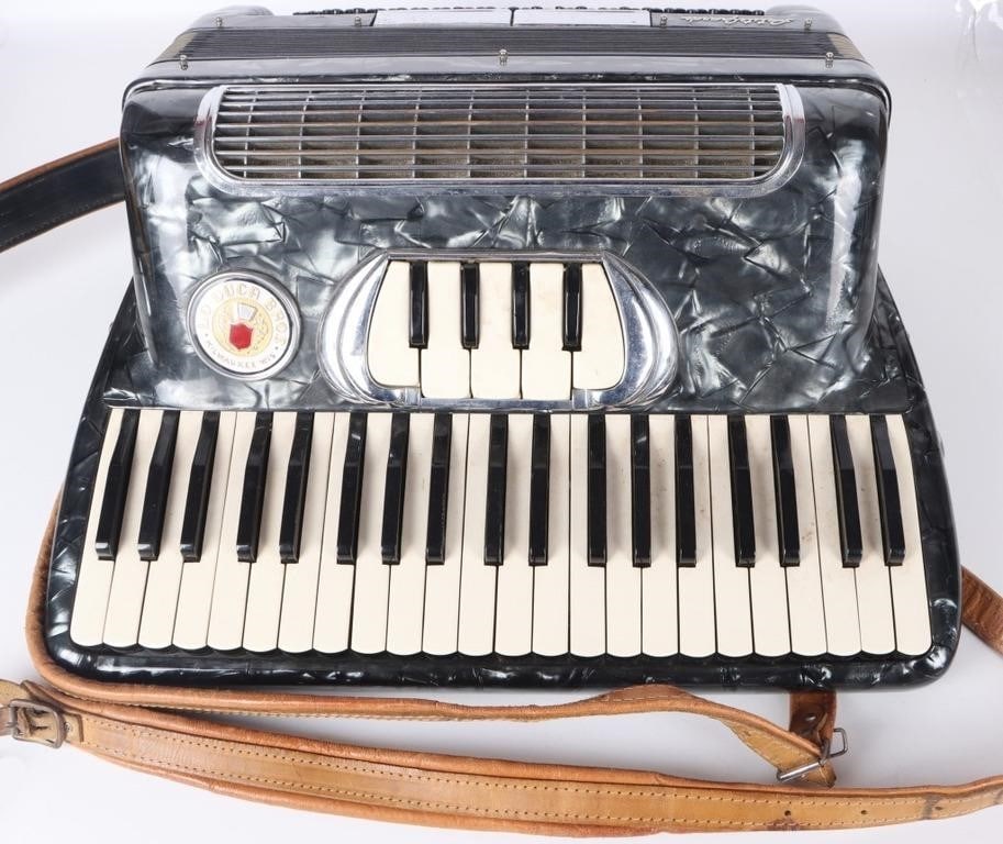 LO DUCA BROS PETIT GRANDE BLACK ACCORDION W/ CASE: Lo Duca Bros Petit Grande black accordion with original case and two replacement reeds. Condition: The piece appears to play music fine. Two keys on the board's right side stick and the strap is broke