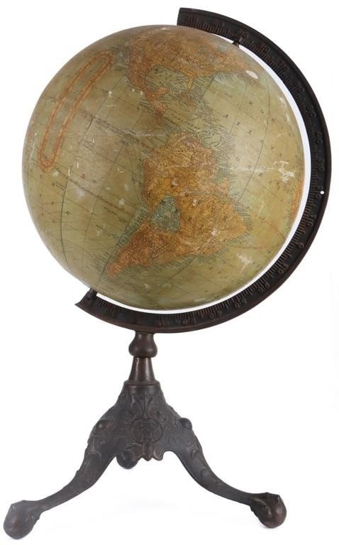 VINTAGE EARLY 1900'S RAND MCNALLY 12' GLOBE: Vintage early 1900'S Rand McNally 12" terrestrial globe mounted on a dark, ornate cast iron stand with claw feet. The stand features a heavy cast iron base with three legs that have decorative ac