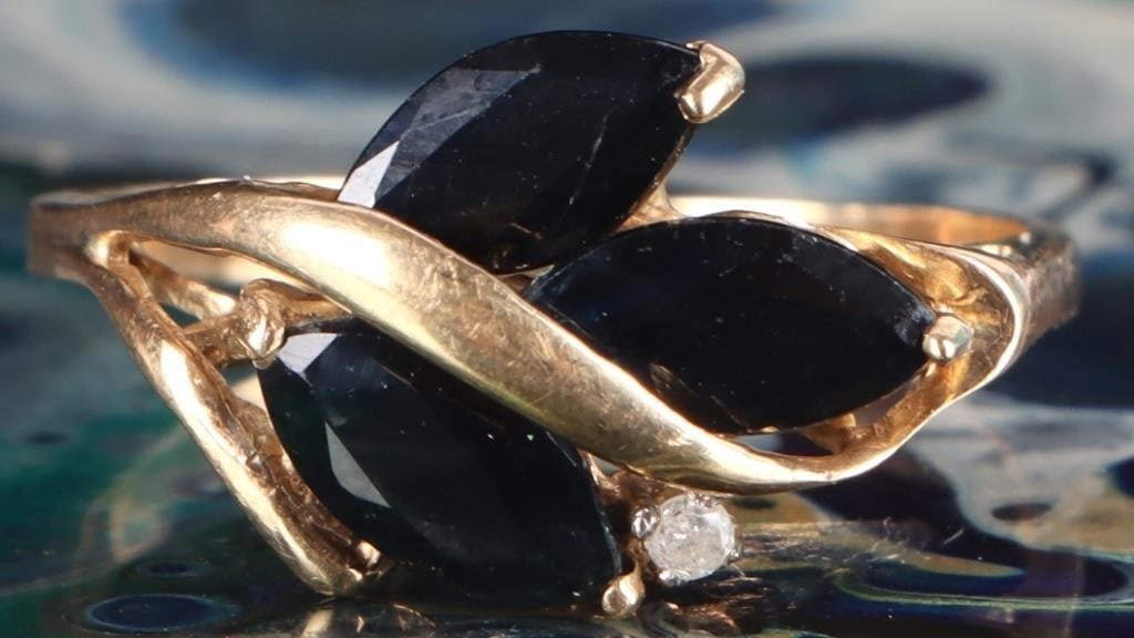 10K YELLOW GOLD BLUE SAPPHIRE DIAMOND LADIES RING: 10K yellow gold blue sapphire diamond ladies ring. Gemstones to include three 0.40ct marquise cut deep blue sapphire, and one 0.015ct round cut diamond.Stone Type: AssortedWeight: 2.43 GramsSize: 7.75