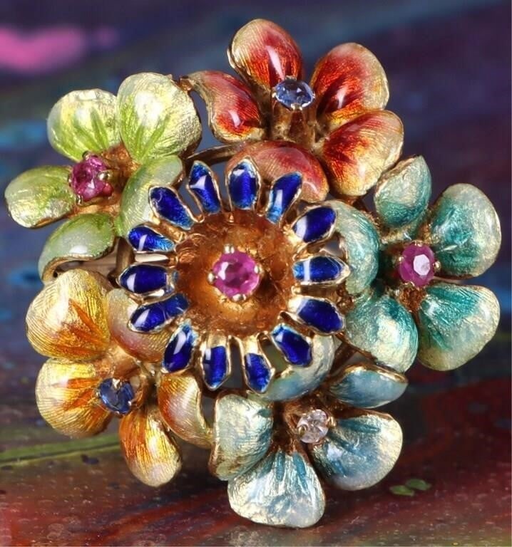 18K YELLOW GOLD ENAMEL FLOWER RUBY TOPAZ RING: 18K yellow gold enamel flower ruby topaz ring. Gemstones to include three 0.04ct round cut pink rubies, two 0.02ct round cut blue topaz, and one 0.02ct round cut CZ.Stone Type: AssortedWeight: 7.29