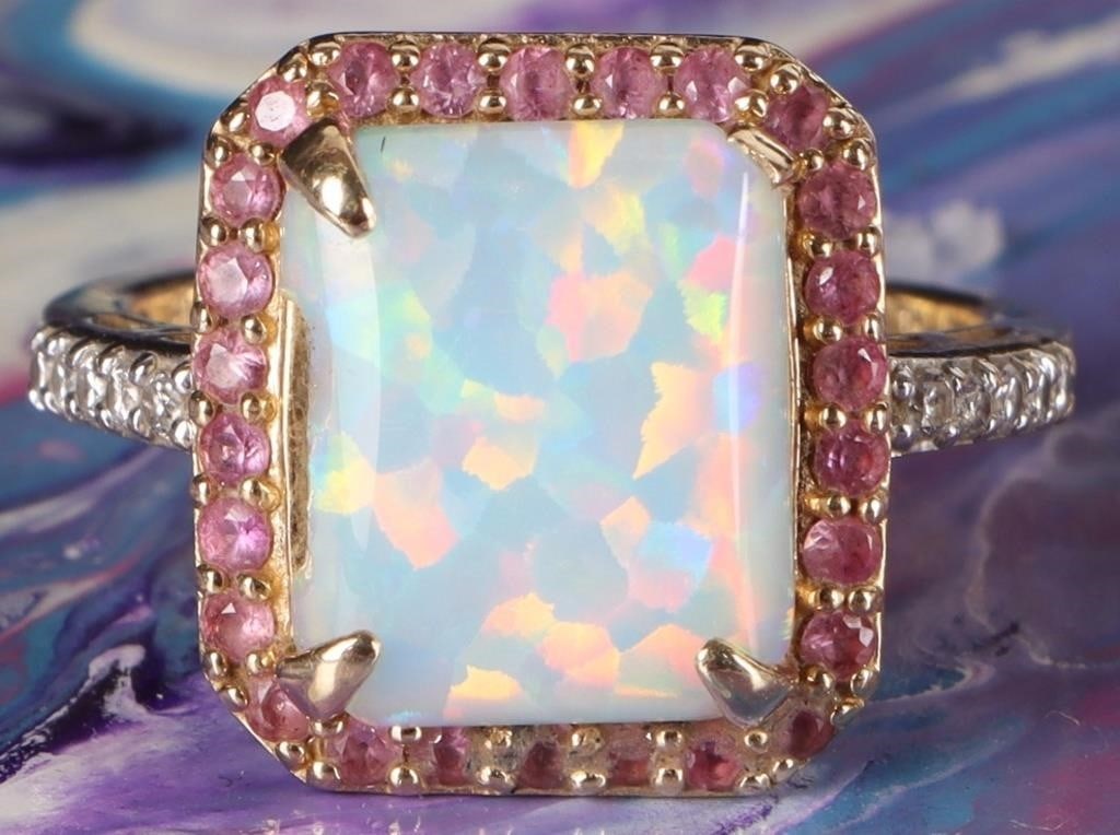 14K YELLOW GOLD OPAL PINK SAPPHIRE DIAMOND RING: 14K yellow gold opal pink sapphire diamond ladies ring. Gemstones to include one 12.02mm X 9.59mm emerald cabochon opal, twenty-six 0.01ct round cut pink sapphire, and ten 0.01ct round cut diamonds.St