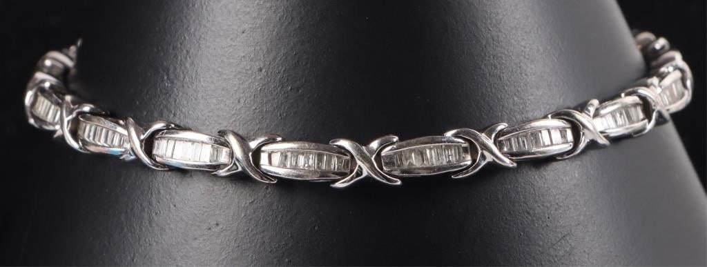 10K WHITE GOLD LADIES BRACELET W/ DIAMONDS: 10k white gold ladies bracelet. Each setting contains a row of melee diamonds, which in total amounts to approximately a 0.765ctw.Stone Type: DiamondWeight: 11.41 gramsSize: 7.5" longCondition: See