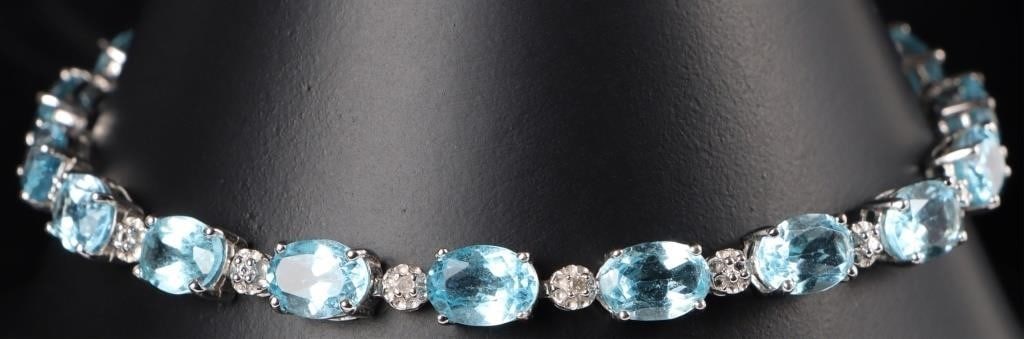 ~8.5CTW TOPAZ & DIAMOND LADIES TENNIS BRACELET: ~8.5CTW oval blue topaz & diamond ladies tennis bracelet set in 10K white gold. The oval blue topaz are an ocean blue hue with small round diamonds separating each stone creating a beautiful