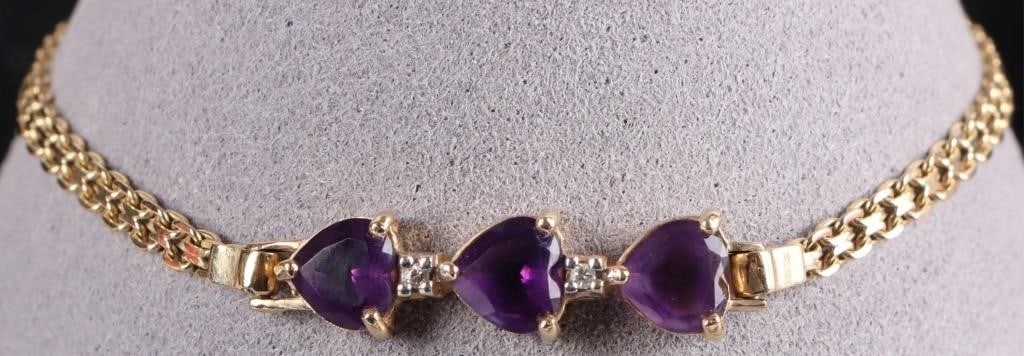 14K YELLOW GOLD AMETHYST DIAMOND LADIES BRACELET: 14K yellow gold amethyst diamond ladies bracelet. Gemstones to include three 0.75ct heart cut amethyst and two 0.01ct round cut diamonds.Stone Type: AssortedWeight: 4.62 GramsSize: 7.25"Condition: