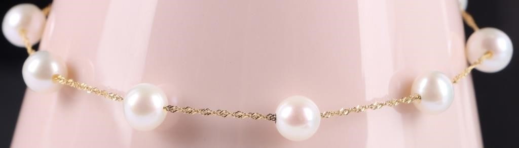 14KT GOLD PEARL STATION BRACELET: 14 karat Yellow Gold Pearl station bracelet. Features luminous pearls stationed along a delicate 14k gold chain. Its classic and minimalist design offers a touch of timeless elegance. perfect for